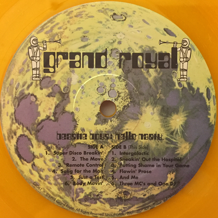 Record label (Side B). “Grand Royal” features the same style of lettering, with a thin ascender for d. Unlike in Countdown, g is monocular. Two weights of  are used for the track list and the credits.