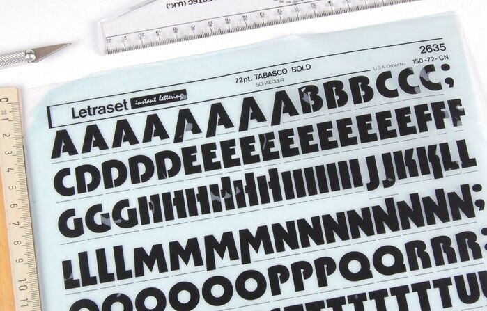 Detail of a dry-transfer lettering sheet showing the caps of Tabasco Bold. Originally released by  in New York, the phototype family spanned three weights (Light, Medium, Bold) plus a biline variant named . The Medium and Bold were adopted by Letraset in 1973/1974. Ascending/descending alternates were available for a range of letters.