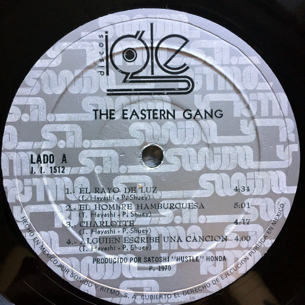 The logo as seen on a record label by Discos Igle. “The Eastern Gang” is set in , the track list in .