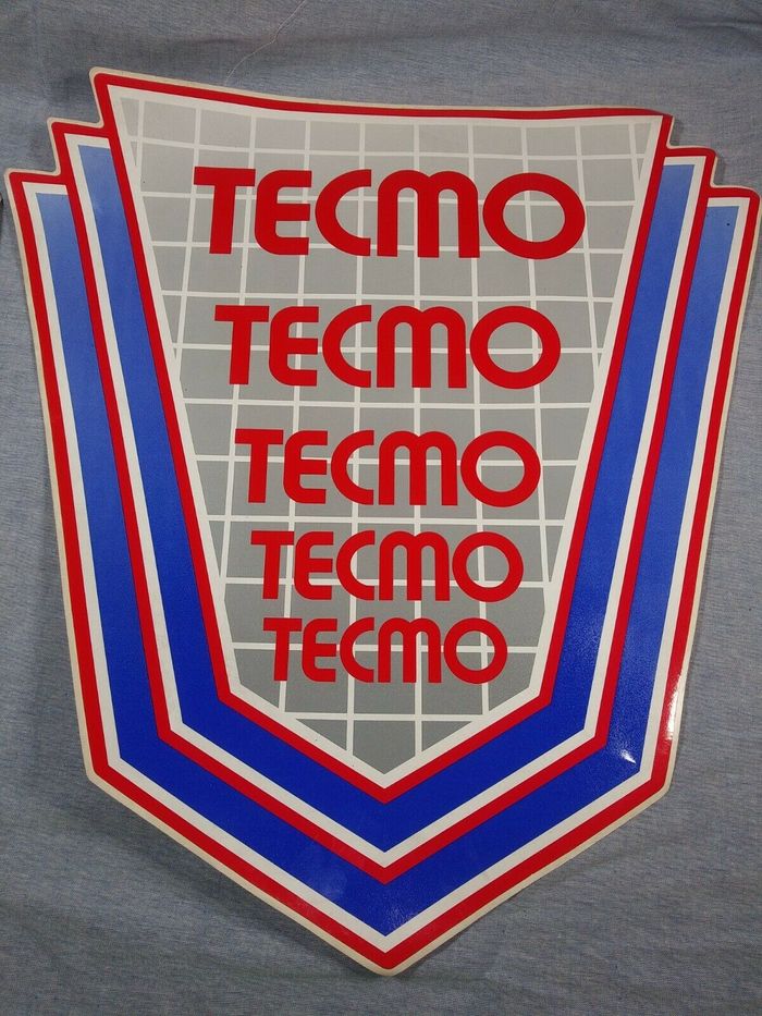 The Tecmo logo in multiple sizes, on the side art decal for a video arcade game cabinet.