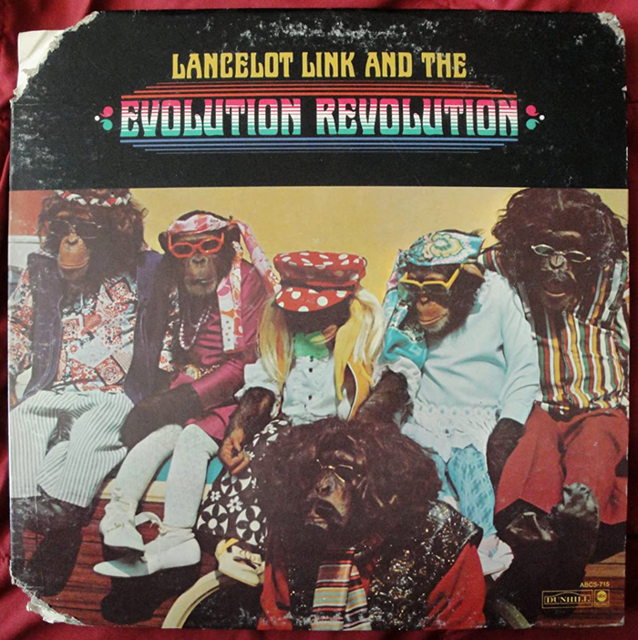 Lancelot Link also had a band, The Evolution Revolution, which released one self-titled album (Dunhill/ABC Records, 1970) of psychedelic bubblegum pop music, with a cover design by Douglas Carr. [More info on Discogs] The typeface chosen for the band is  (also known as Domingo), used in all caps.