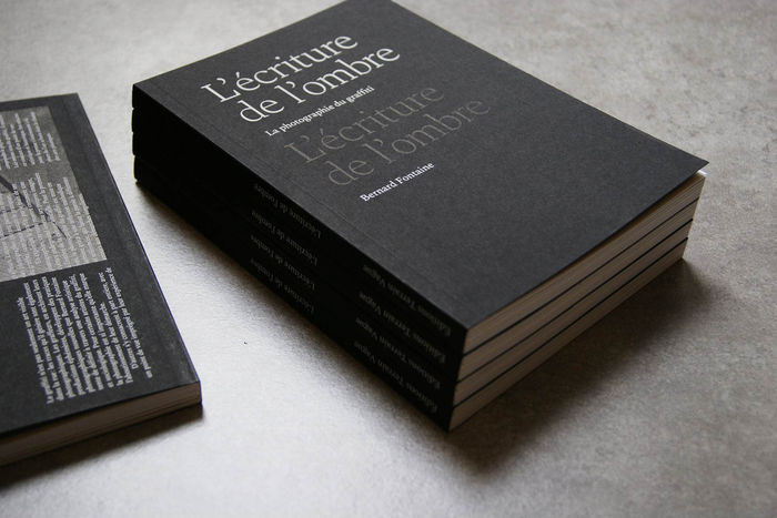 The title on the screen-printed cover features the lightest weight of the Spectral family. In a self-referential graphic allusion, it’s repeated a second time, black on black.