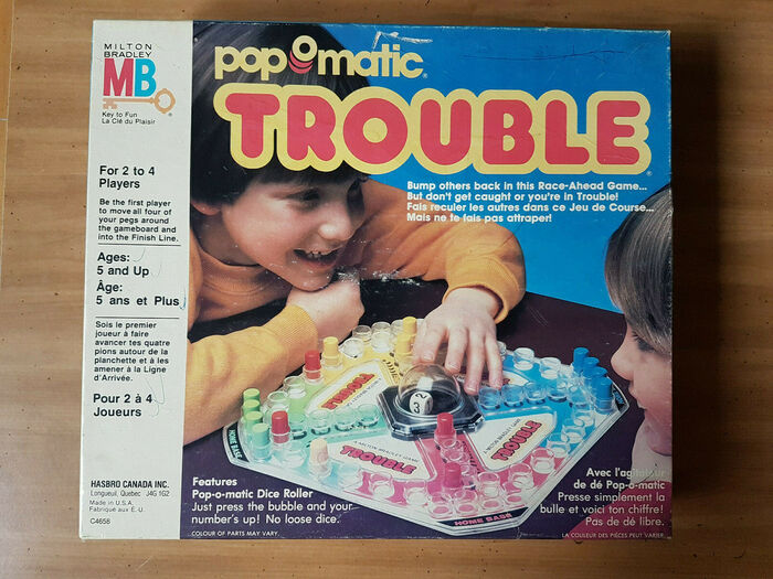 Trouble by Hasbro Canada Inc., 1986, with game instructions in English and French. The white text at  the bottom is set in .