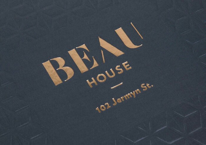 “BEAU” uses  in modified form, with added strokes in A and U. Smaller text set in Verlag.