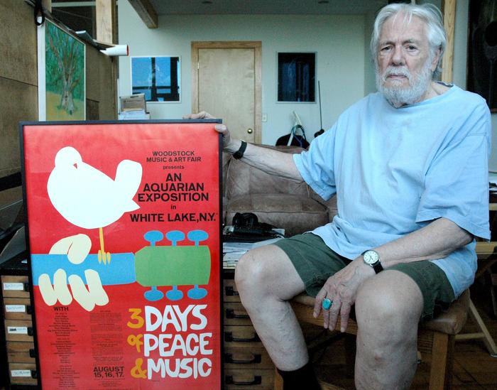 Designer Arnold Skolnick with his iconic Woodstock festival poster.