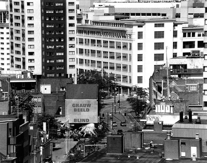 “Grauw Beeld Blind by Rémy Zaugg was painted as a mural on this building for the travaux publique project in 1996. Textual works of art have been created throughout the city for this exhibition of the van Abbe museum and Peninsula foundation.”