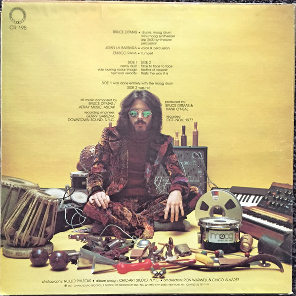 Aeray Dust back cover (1977), set in . Album design by Chic-Art Studio, N.Y.C., with art direction by Rob Warwell &amp; Chico Alvarez and photography by Rollo Phlecks.