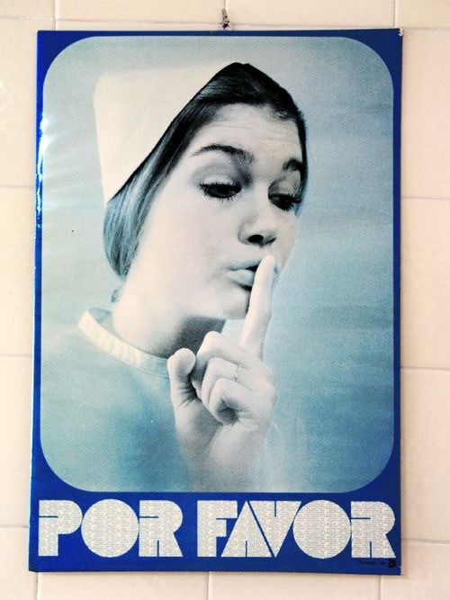 A copy that has lost its colors of the years, hanging on a tiled wall.
