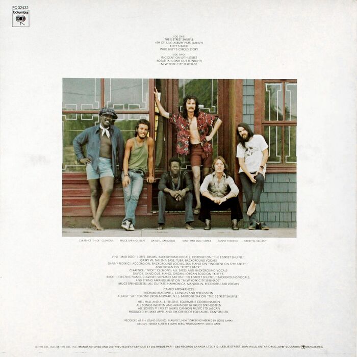 Back cover of a Canadian pressing from 1975. From Wikipedia:


The back photo for the album featured six members of Springsteen’s backing E Street Band standing in a doorway of an antique store on Sairs Ave in the West End section of Long Branch, New Jersey.