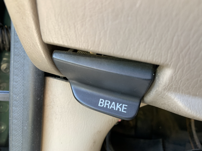 Parking brake release handle on a 1997–2004 Ford F-150 pickup truck. The lettering is applied using “pad printing” to the plastic substrate. The distinctive, groovy K is unmistakable.