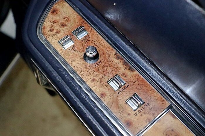 Modula imprinted on simulated woodgrain trim, 1987 Lincoln Town Car.