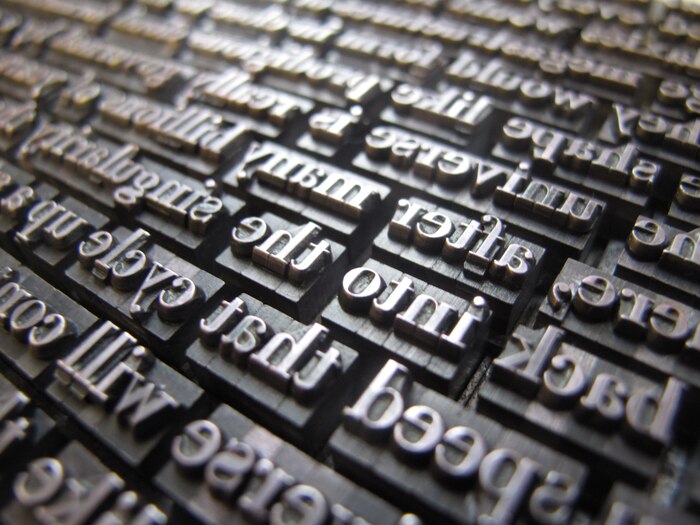 A typeset poem in metal Bodoni.