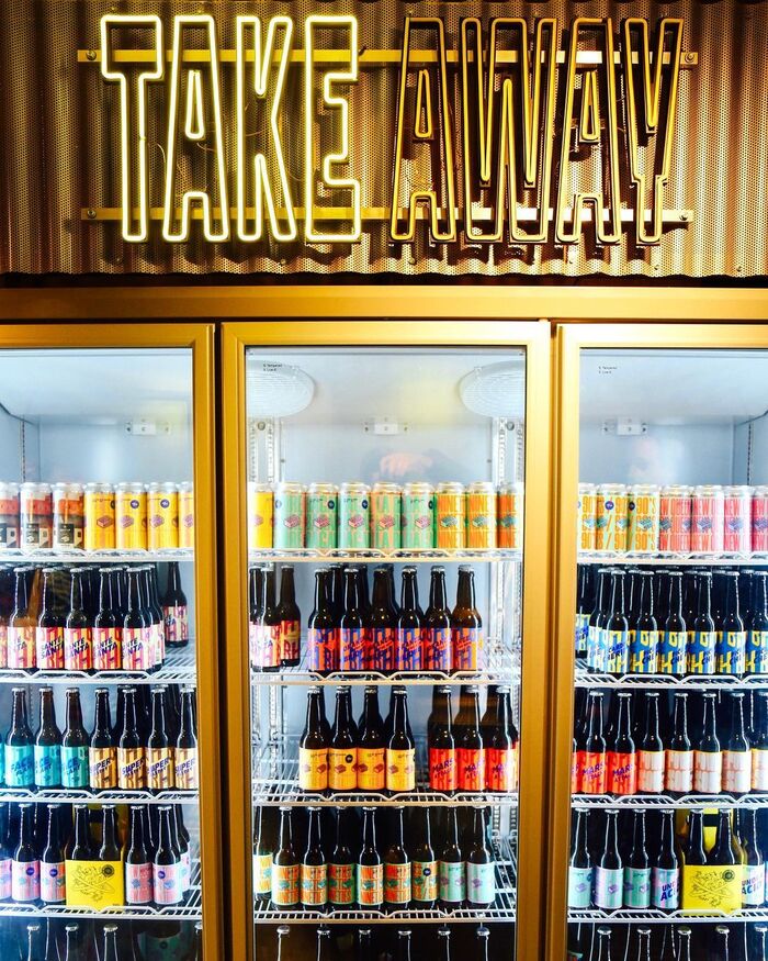 Neon sign with outlined Signal Compressed above the take-away fridge