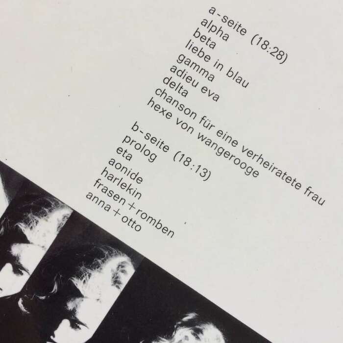 The back cover with the track names is set in all-lowercase letters from light .