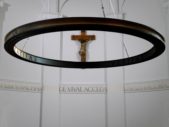 The apse wall and cast iron light ring.