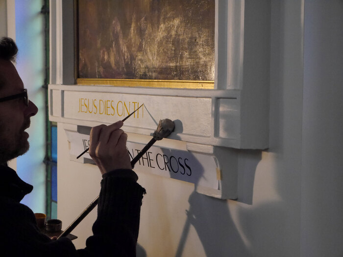 Phil Surey painting the Stations of the Cross.