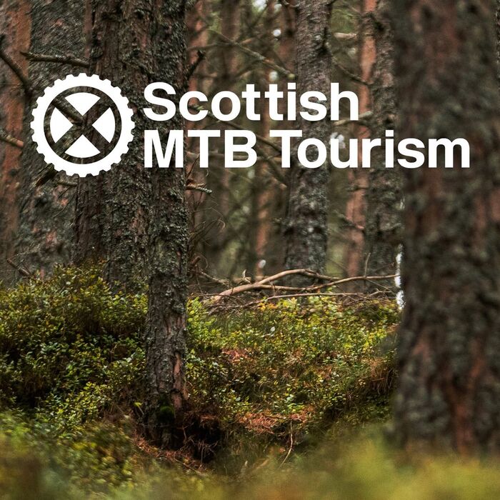 Logo for Scottish Mountain Bike Tourism, with the Saltire in a sprocket wheel