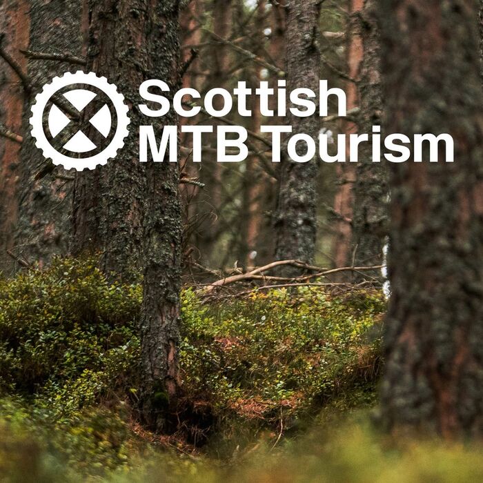 Logo for Scottish Mountain Bike Tourism, with the Saltire in a sprocket wheel
