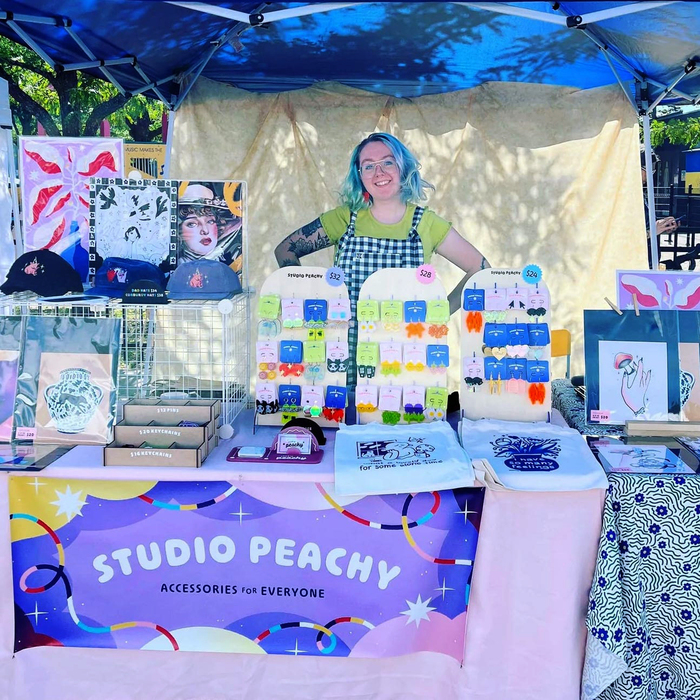 Katrin Emery with a table full of Studio Peachy acessories; Ohno Softie is used on everything from the shop sign to the price stickers.