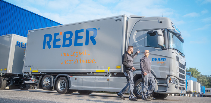 The REBER logo is placed in at least four different sizes on the trucks