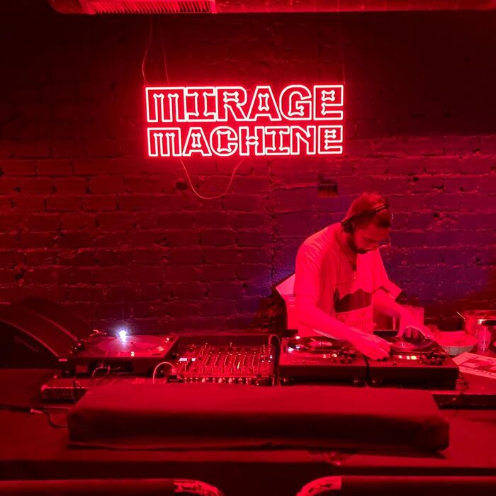 The Mirage Machine logo in Minotaur Beef as illuminated sign above the DJ booth