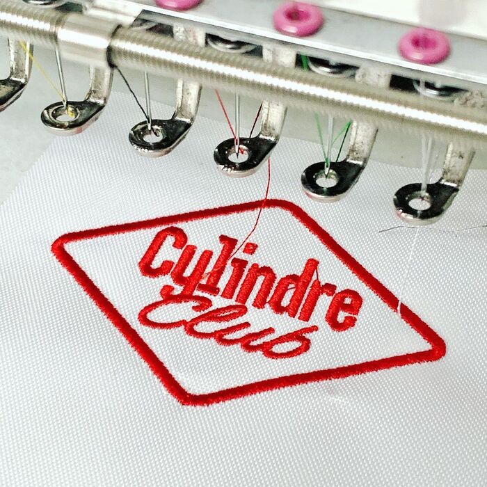 Embroidered bike patches in the making at Broderie Lévêque (500 m)