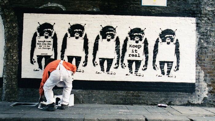 First appearing in 2002, Banksy’s monkeys feature messages set in a stencilled version of the bold weight of Courier New.