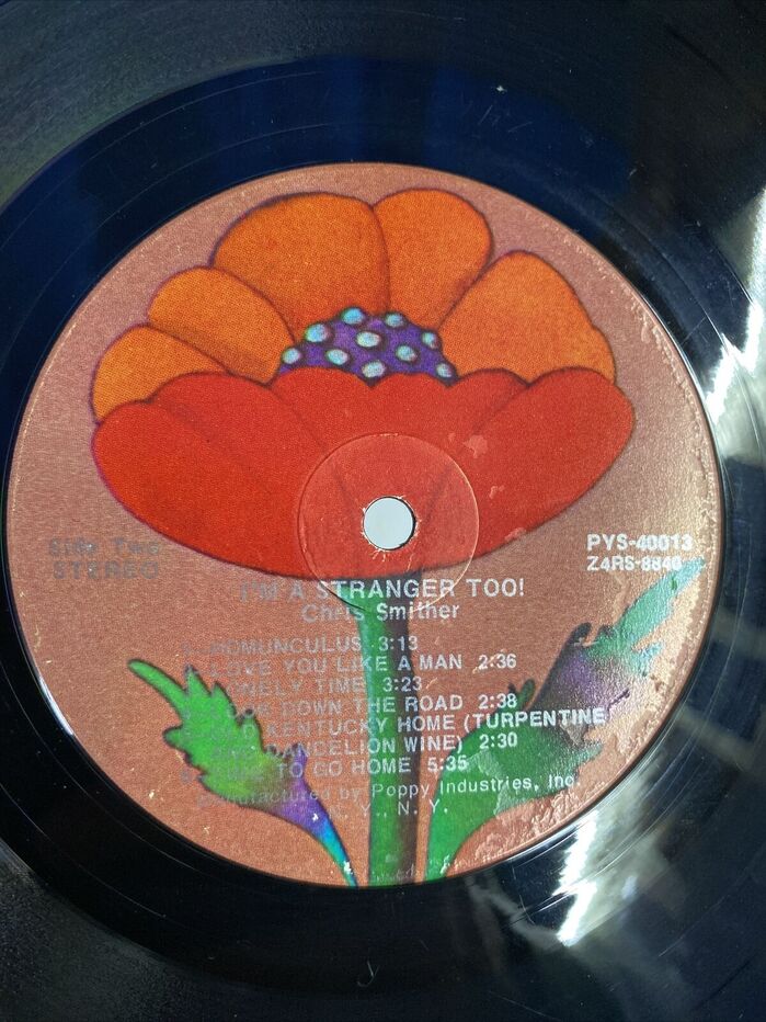 The record label with Glaser’s illustrated poppy and text printed in 