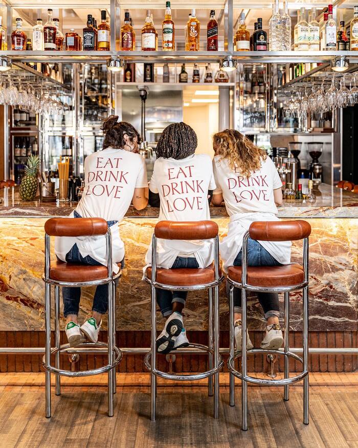 Staff members wearing T-shirts with the restaurant’s motto