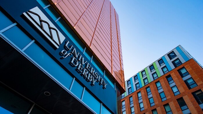 The previous logo, still in use on the entrance of one of the university’s locations in 2021.