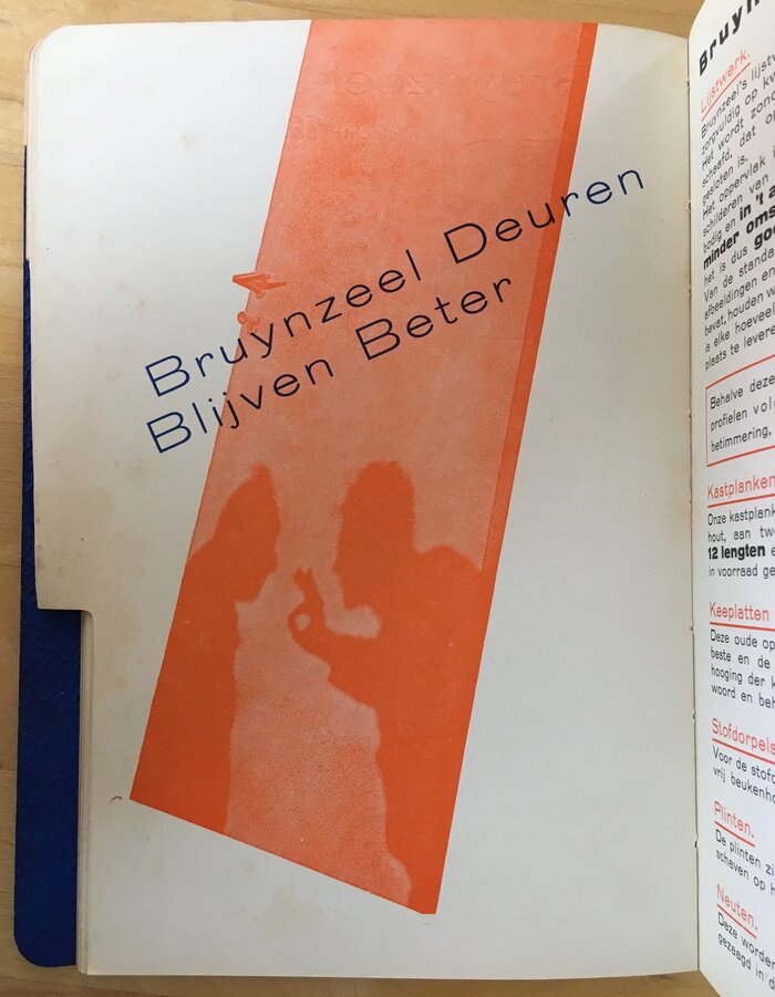 “Bruynzeel doors remain superior”. The reflection in the door shows the silhouettes of two people, one of them giving the OK sign.