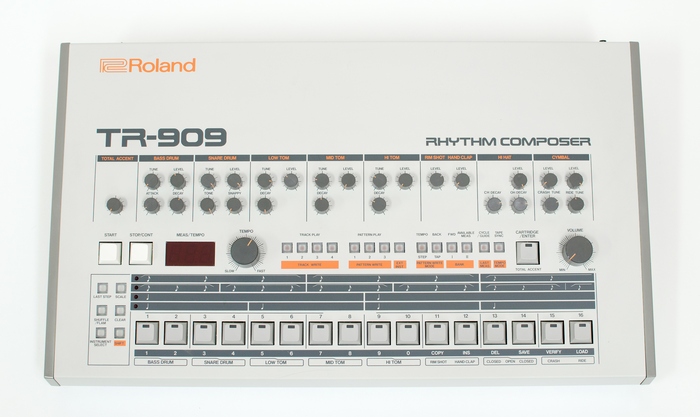 Front panel of the Roland TR-909, with model number and device name set in Earth.