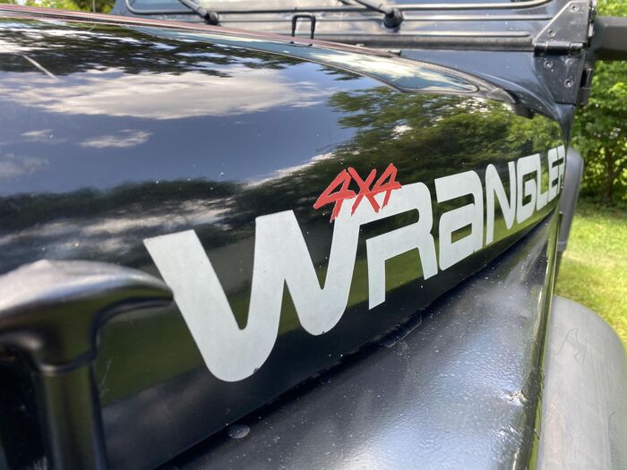 1993 Jeep Wrangler 4x4, detail. The 4x4 looks to be hand-lettered in a brush style.