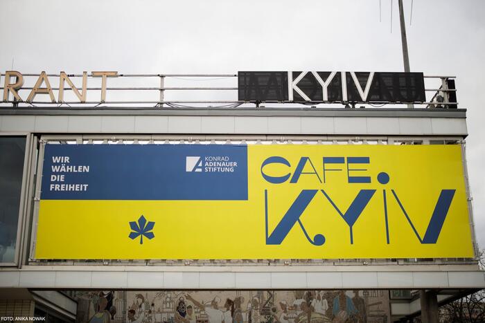 Cafe Moskau becomes Cafe Kyiv. The temporary sign is based on , like the original 1960s neon letters.