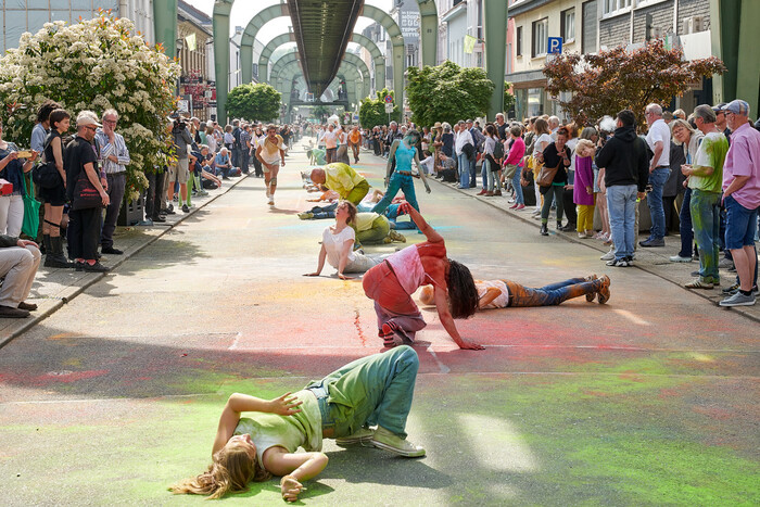 The dancers performing in the streets of Wuppertal, below the famous Schwebebahn