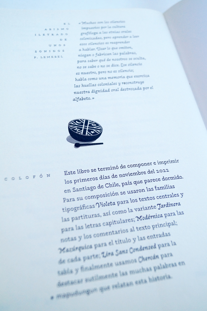 The colophon is divided by a drawing of a Cultrún, a traditional Mapuche drum.
