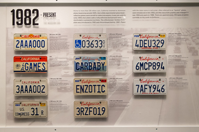 A panel at the Peterson Automotive Museum: “The scripted red ‘California’ was introduced in 1993 and went through three different type sizes, starting with this comparatively small script and settling, in about 1997, to the large script which is seen on plates today.”