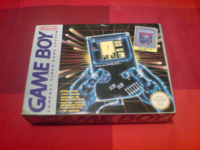 International (or American) box design for the Game Boy. The logo uses much bolder letterforms than on the Japanese box and the Game Boy itself. “Compact video game system” is in italic caps from Gill Sans as well. The list of items is set in , again in italic caps.