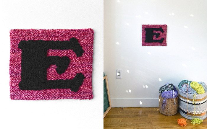 Embossed E set in  (designed by  and released by ) at 680 pt on an English Rose background