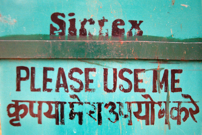 An eroding Sintex logo with hand-painted instructions in English and Hindi, seen in Khajuraho
