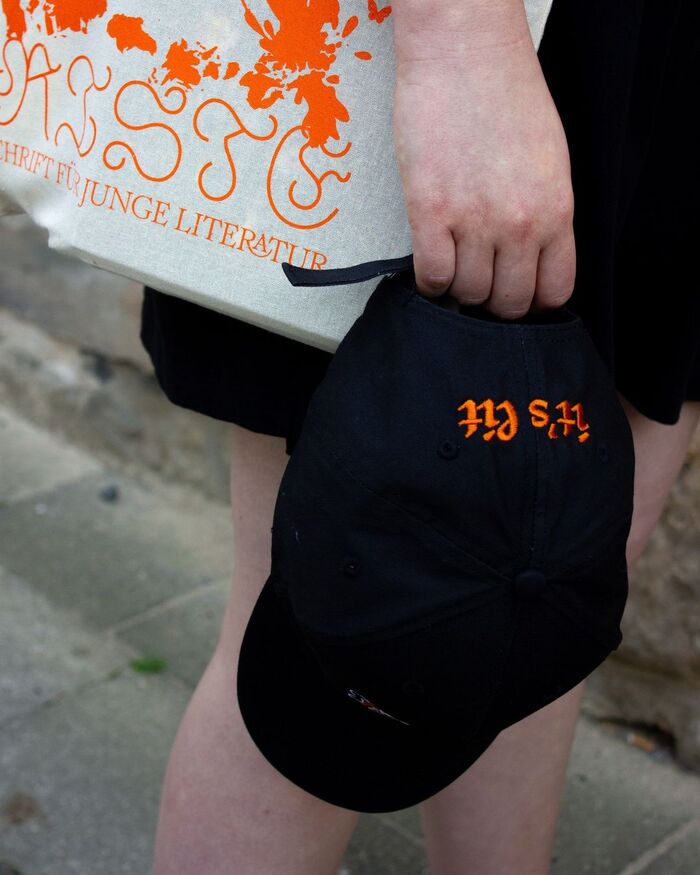 Astloch, Romie, JAF Herb, and Monument Grotesk were also used for the merch items, a tote bag and a cap.