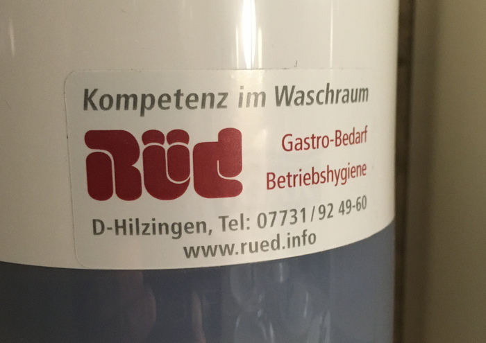 “Competence in the washroom” – sticker advertising Rüd’s services