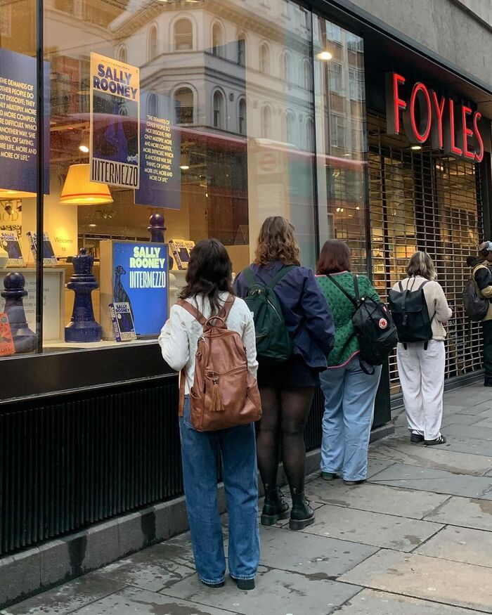 Shop window decorated with promotional posters and oversized chess pieces