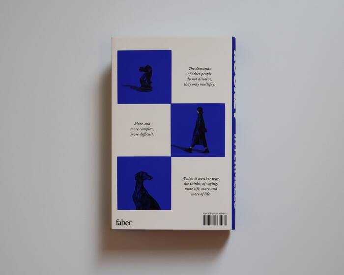 The back of the jacket continues the chess theme with blue and white fields. The typeface is an italic Garamond, possibly .