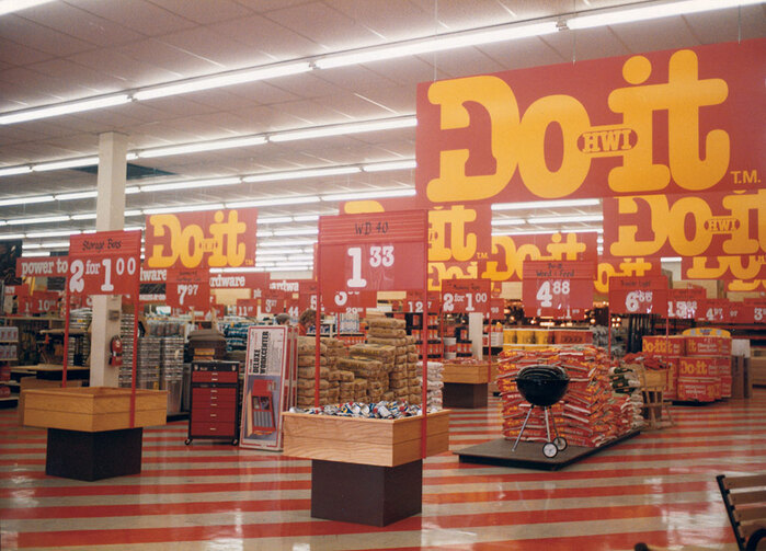 Typical Do it Center interior in 1982. Upper section of price signage held individual characters (white on transparent plastic) to spell out whichever item was on display, though these are not used in this photo.