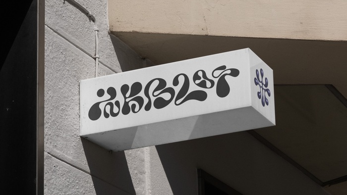 The organic letterforms of the logotype are custom drawn.