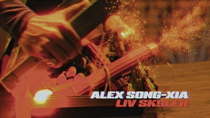 Screenshot from opening credits sequence of episode 1. The text displays the player’s name “ALEX SONG-XIA” in white and the character’s name “LIV SKYLER” in red, both in Sneakers Script.