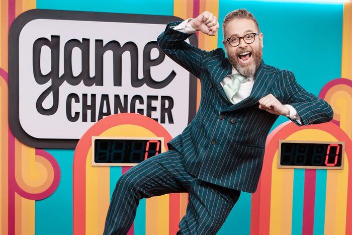 Host Sam Reich jumping joyously on the Game Changer set