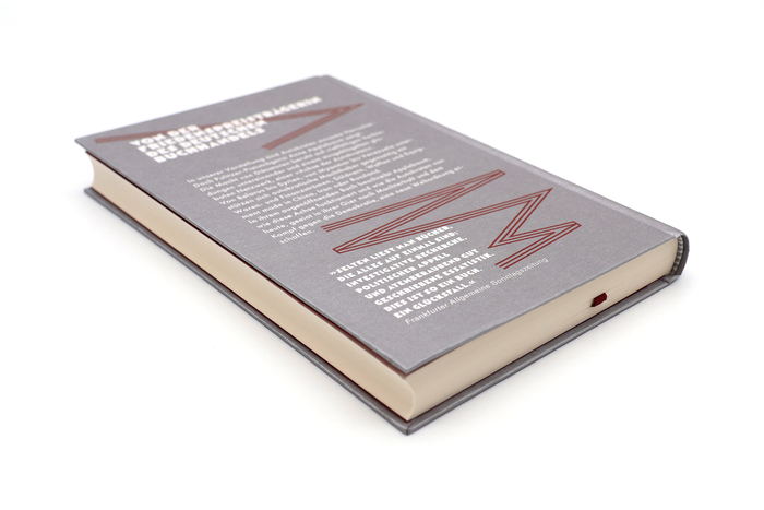 The synopsis on the back cover is set in . The blurb by FAS features more AM Tripoli, with a different sans used for the credit line.