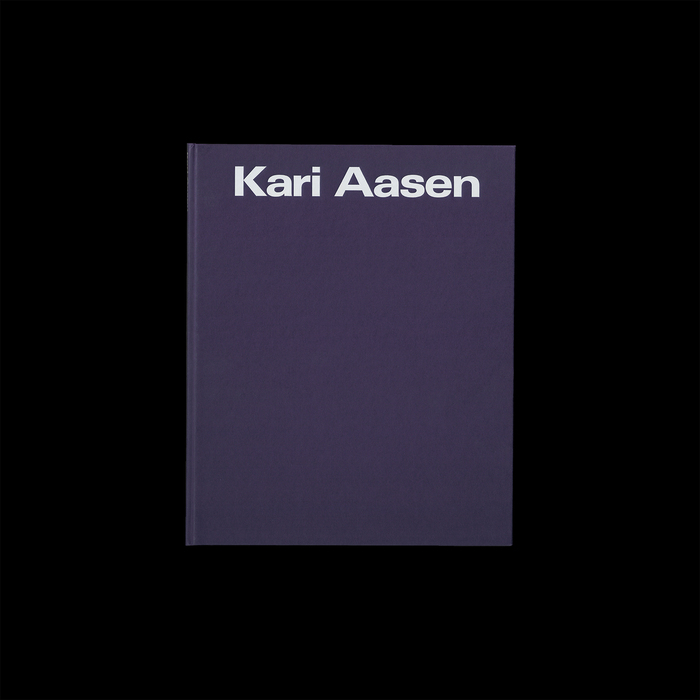 The title is foil-blocked in eggshell on the purple hardback, and set in a modified Univers Extended